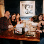 People enjoying drinks at a high-top table