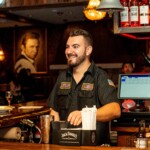 a bartender smiling looking at a guest
