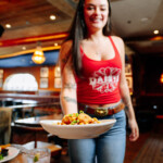 Waitress handing an entree to a guest
