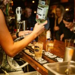 a bartender pouring a shot