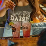 a bartender finishing some drinks
