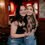 Two girls smiling and hugging