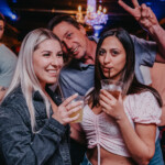 People enjoying a drink and smiling