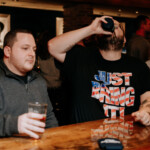 Two guys enjoying some drinks at the bar